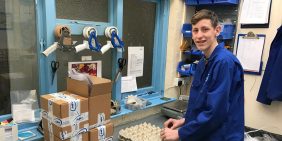 Adam packing brass CNC components during his placement with APT