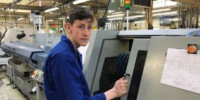 Our apprentice Adam monitoring a sliding head lathe